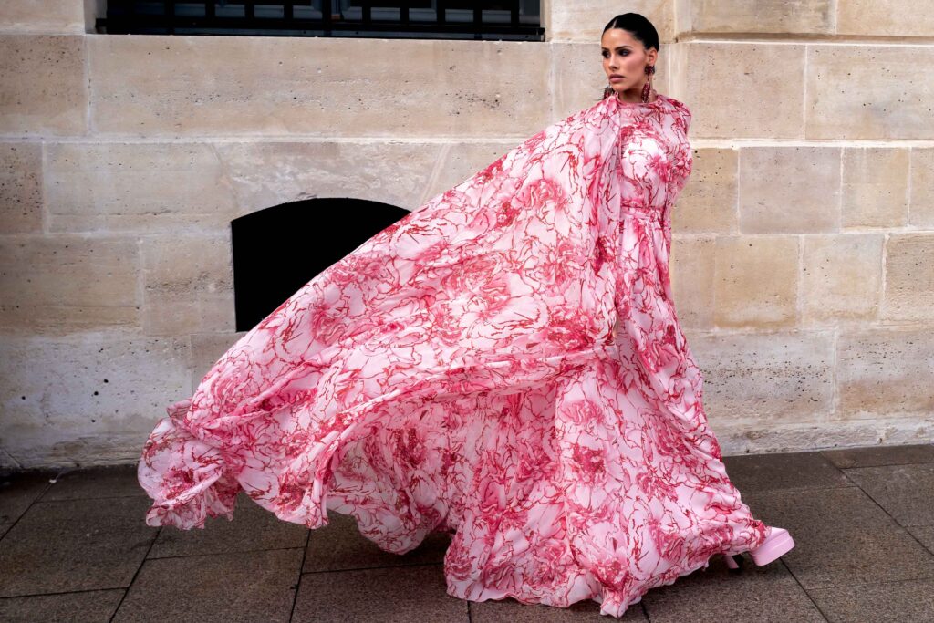 Dy Miryan wears a pink flower print maxi dress Street Style After Giambattista Valli SS24 Paris Fashion Week