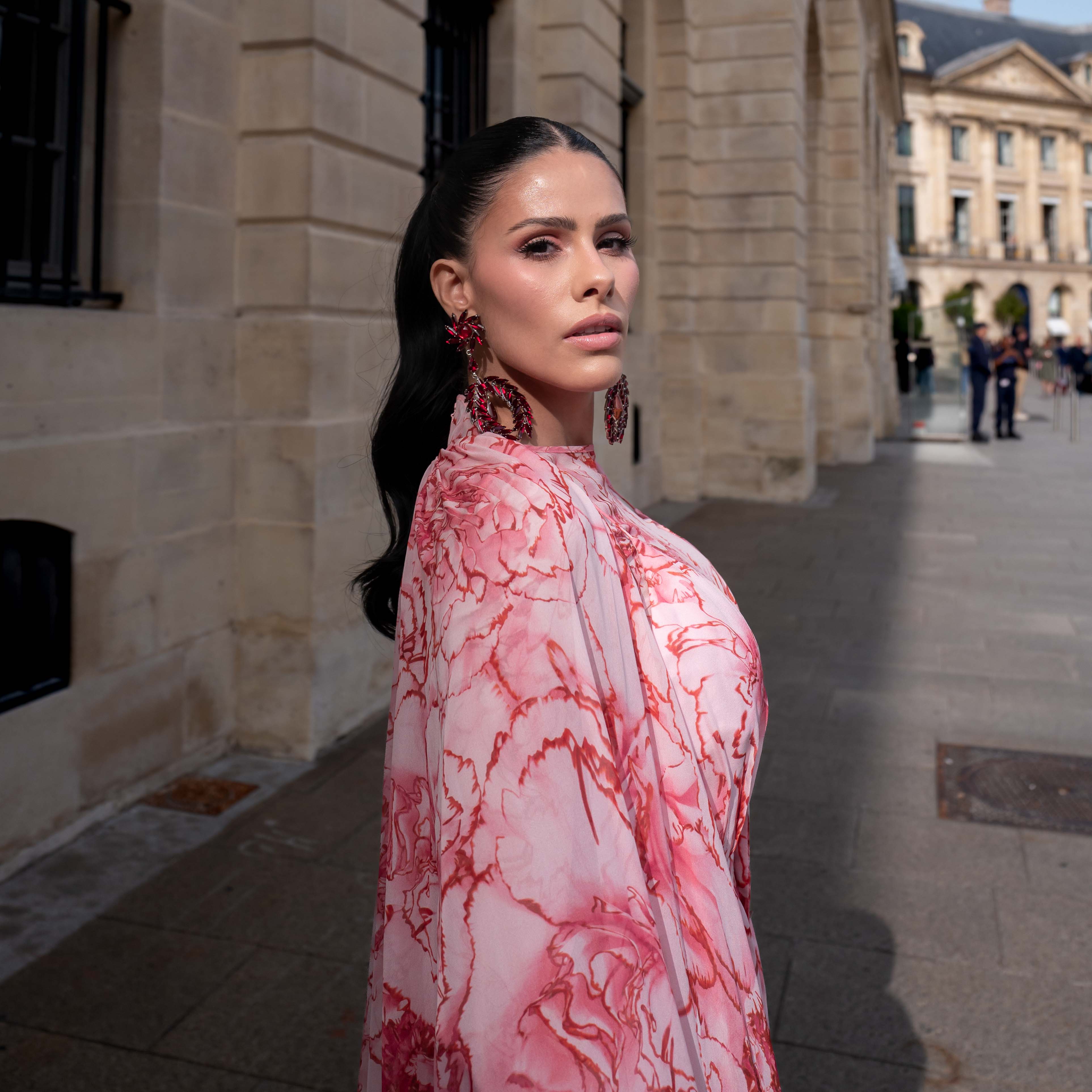 Dy Miryan wears a pink flower print maxi dress Street Style After Giambattista Valli SS24 Paris Fashion Week